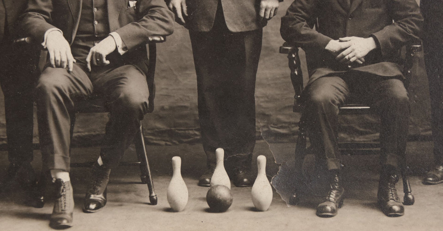 Lot 084 - Antique Boarded Photograph Of Bowling Team Of Five Men Posing With Three Bowling Pins And Bowling Ball, Note Loss To Lower Left Corner, Hole To Left Of Center Mans Head