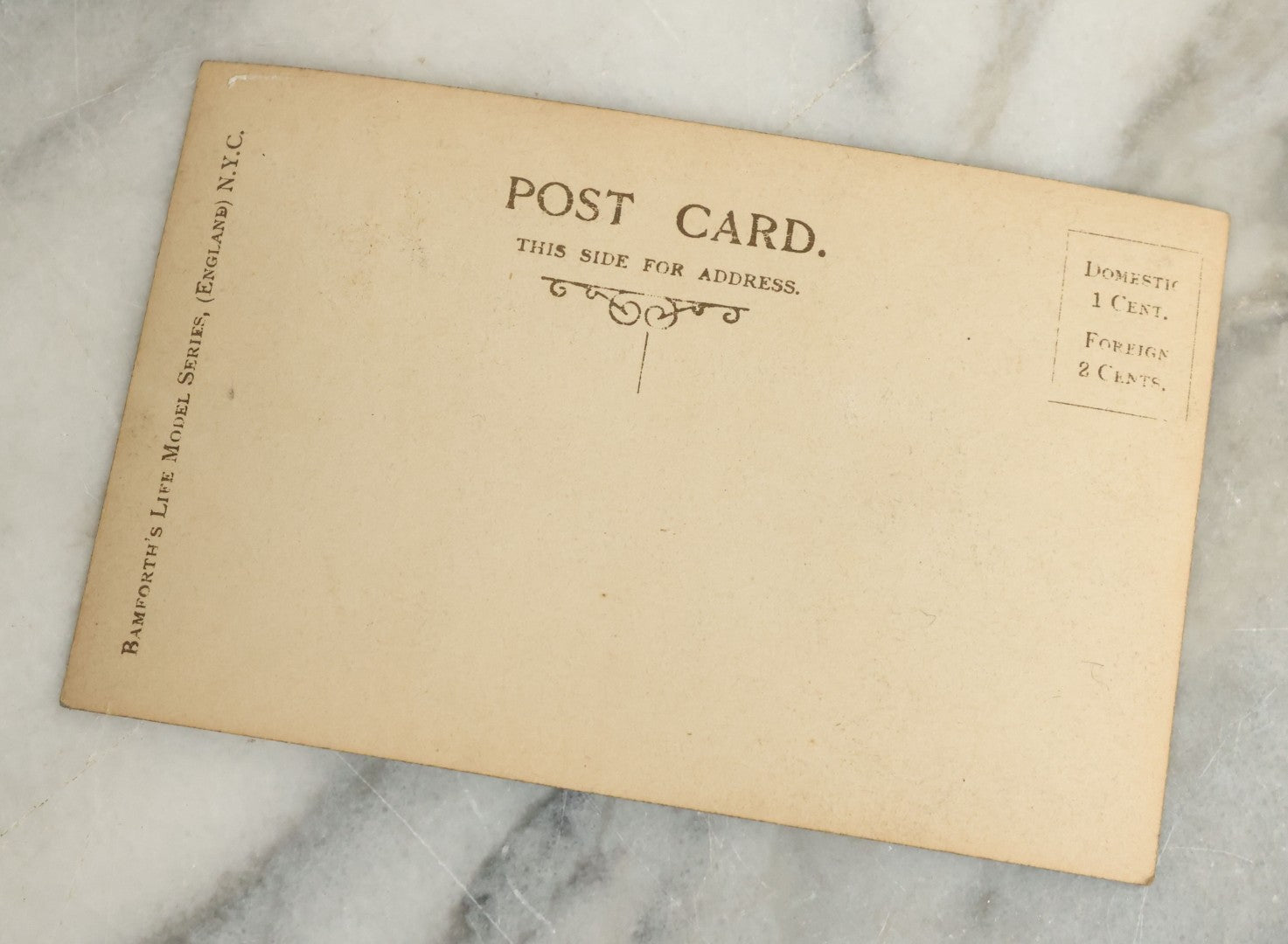 Lot 097 - Grouping Of 35 Antique Photographic Postcards From Bamforth's "Life Model Series," England And New York City, With Many Posed Studio Photographs And Series Including Rock Of Ages, The Little Hero, Excelsior, And Others