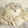 Lot 104 - Vintage Large Size Pincushion With White Silk And Dozens Of Antique With Dozens Of Glass Ball Head Sewing Pins, As Found