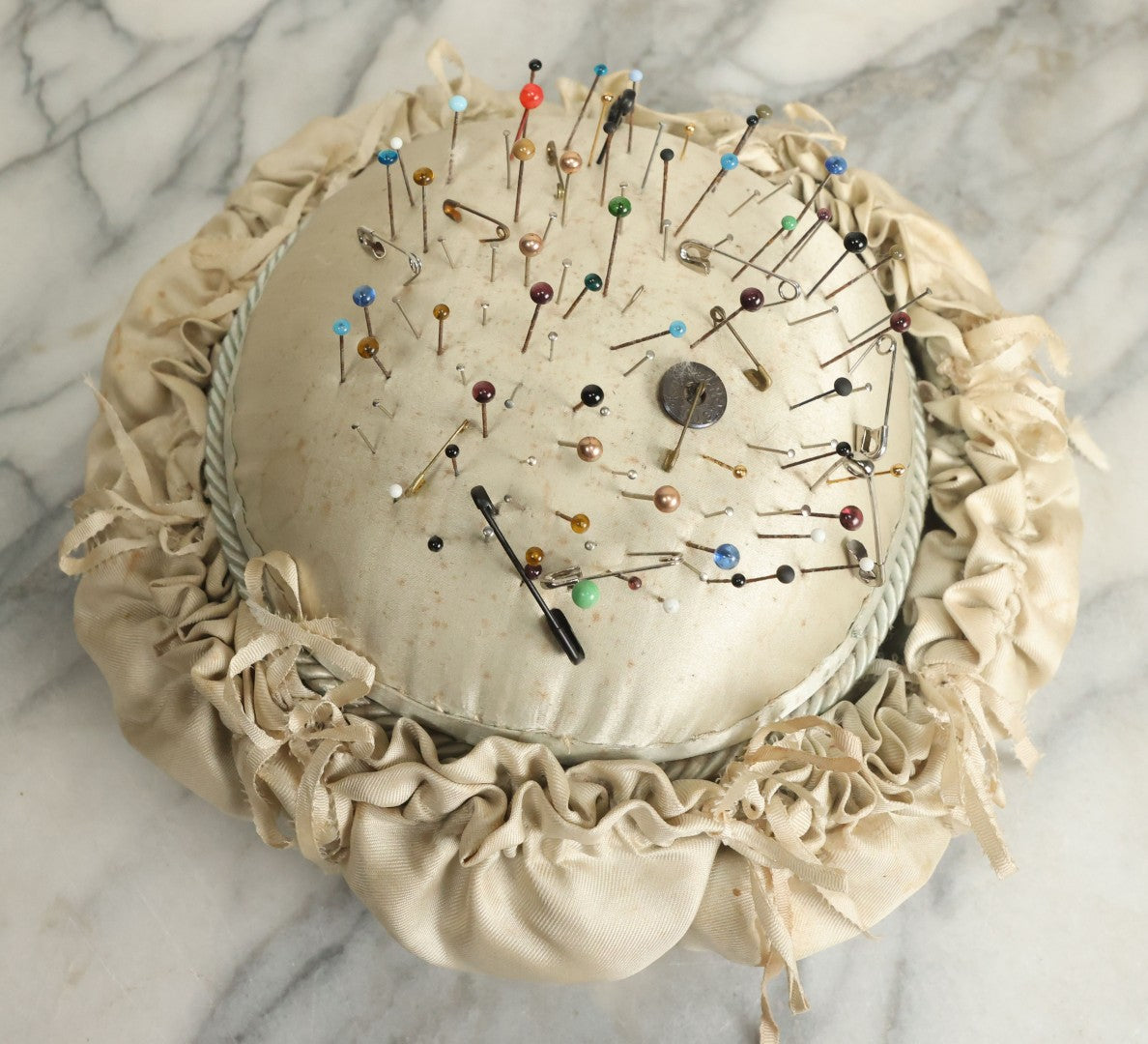 Lot 104 - Vintage Large Size Pincushion With White Silk And Dozens Of Antique With Dozens Of Glass Ball Head Sewing Pins, As Found