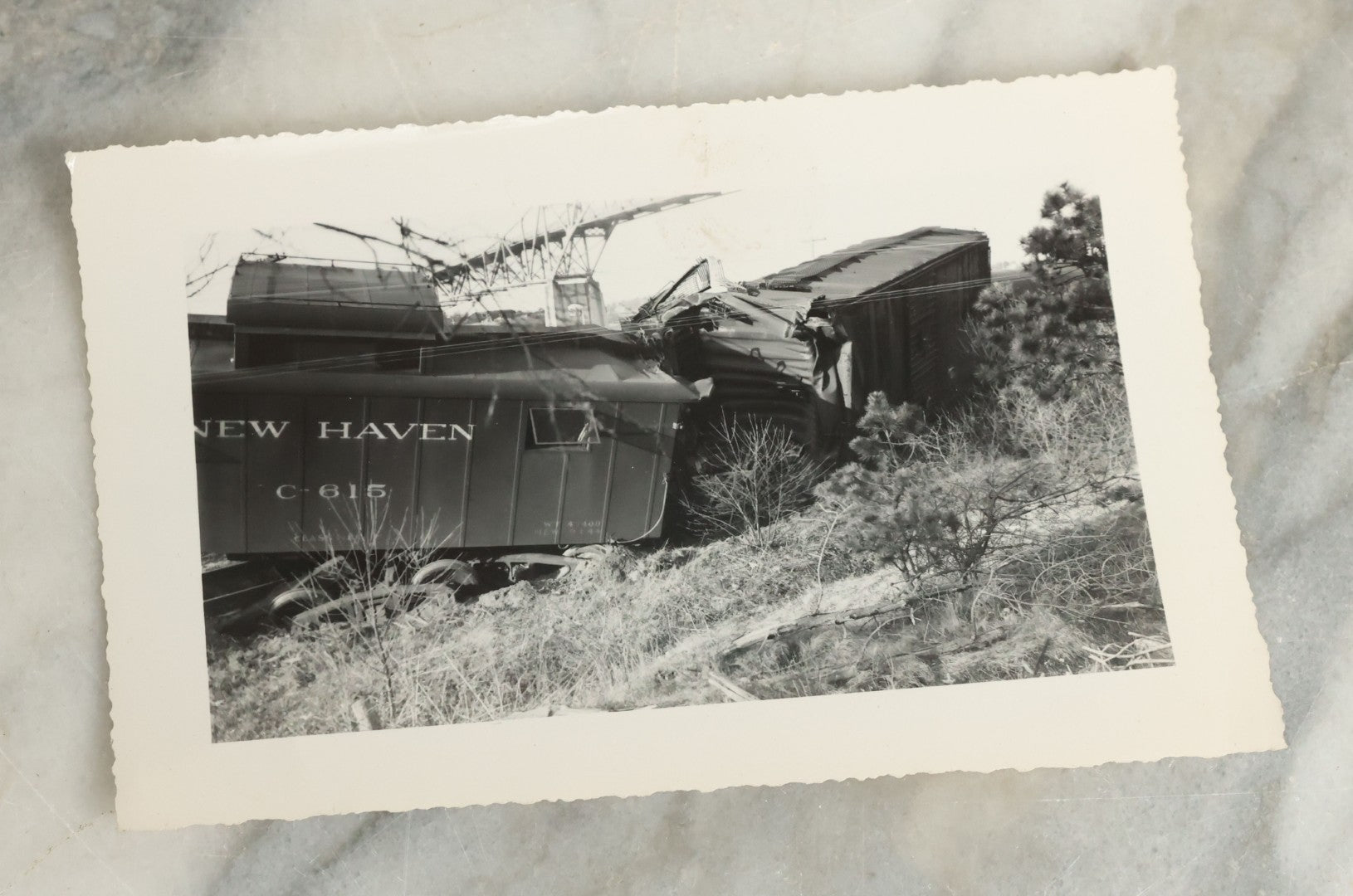 Lot 107 - Grouping Of Five Vintage Snapshot Photographs Showing A Railroad Collision And Derailment With A New Haven Caboose And A Locomotive With Trust Bridge Visible In Background, Circa 1940