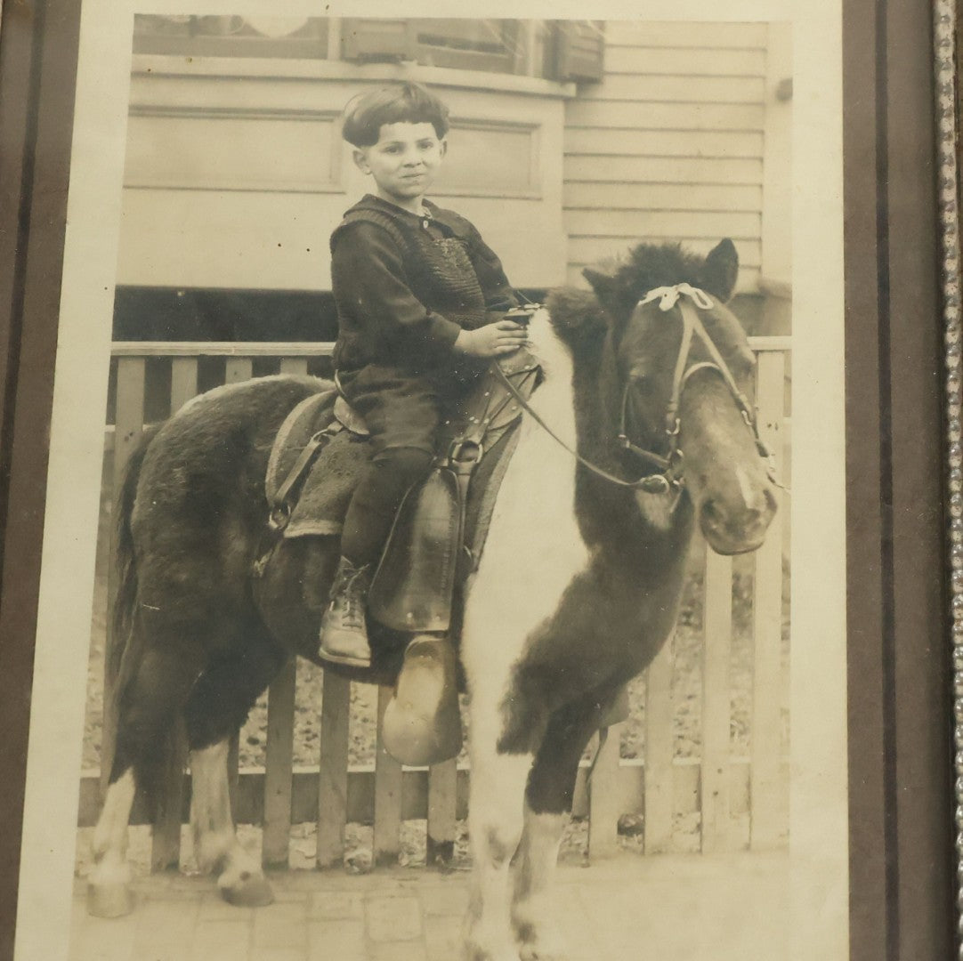 Lot 109 - Vintage Boarded Photograph Of Young Boy With Bowl Cut Riding A Brown And White Pony In Vintage Frame, 5-1/8" x 7-1/8"