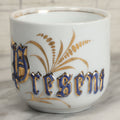 Lot 130 - Antique Porcelain Mug With Blue And Gold "Present" Decoration, Makers Mark On Bottom