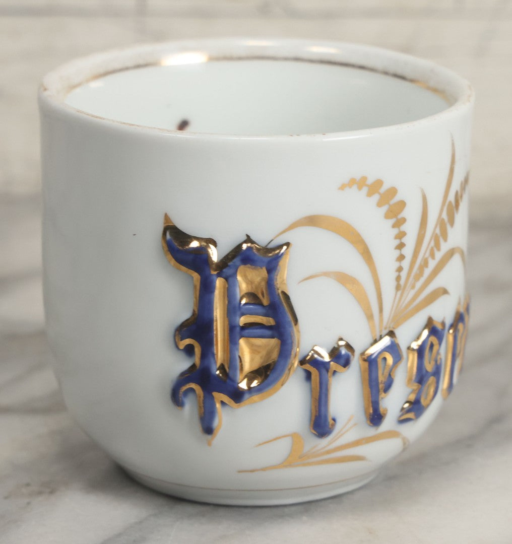 Lot 130 - Antique Porcelain Mug With Blue And Gold "Present" Decoration, Makers Mark On Bottom