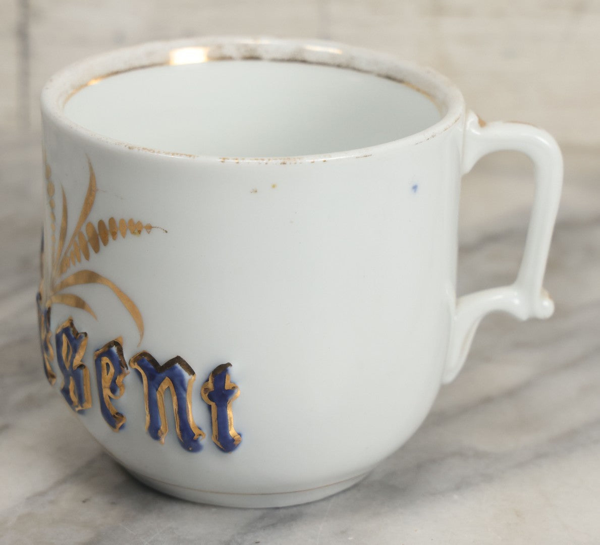 Lot 130 - Antique Porcelain Mug With Blue And Gold "Present" Decoration, Makers Mark On Bottom