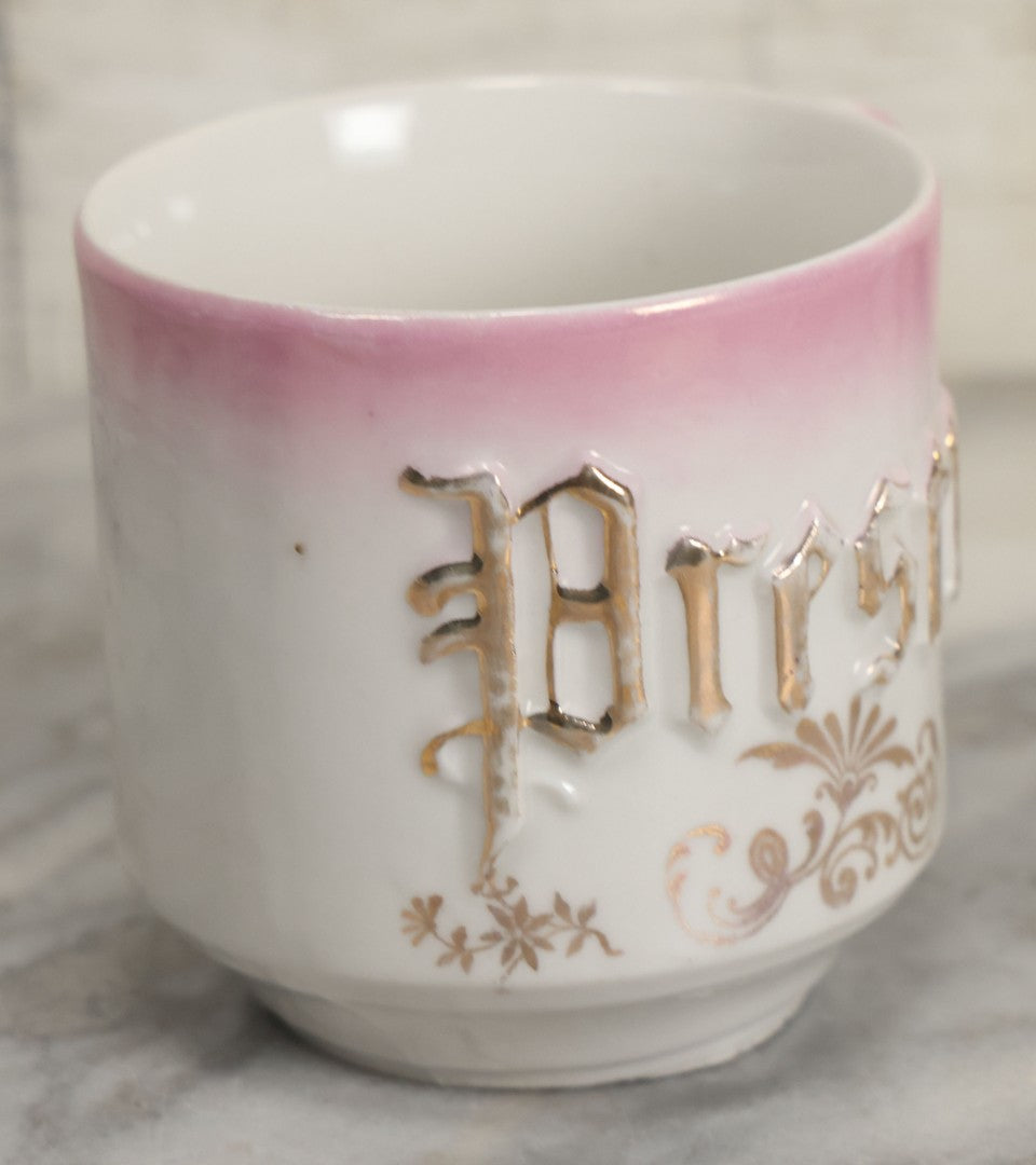 Lot 131 - Antique Porcelain Mug With Pink And Gold "Present" Decoration, Bottom Marked Made In Germany