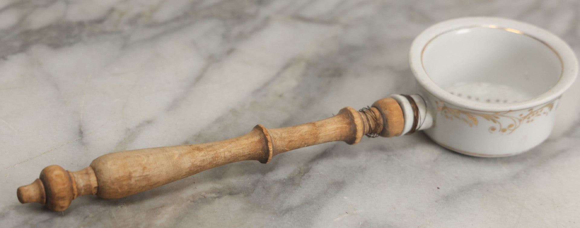 Lot 132 - Vintage Porcelain Tea Strainer With Gold Painted Details And Wire Attached Wooden Handle, Note Repairs