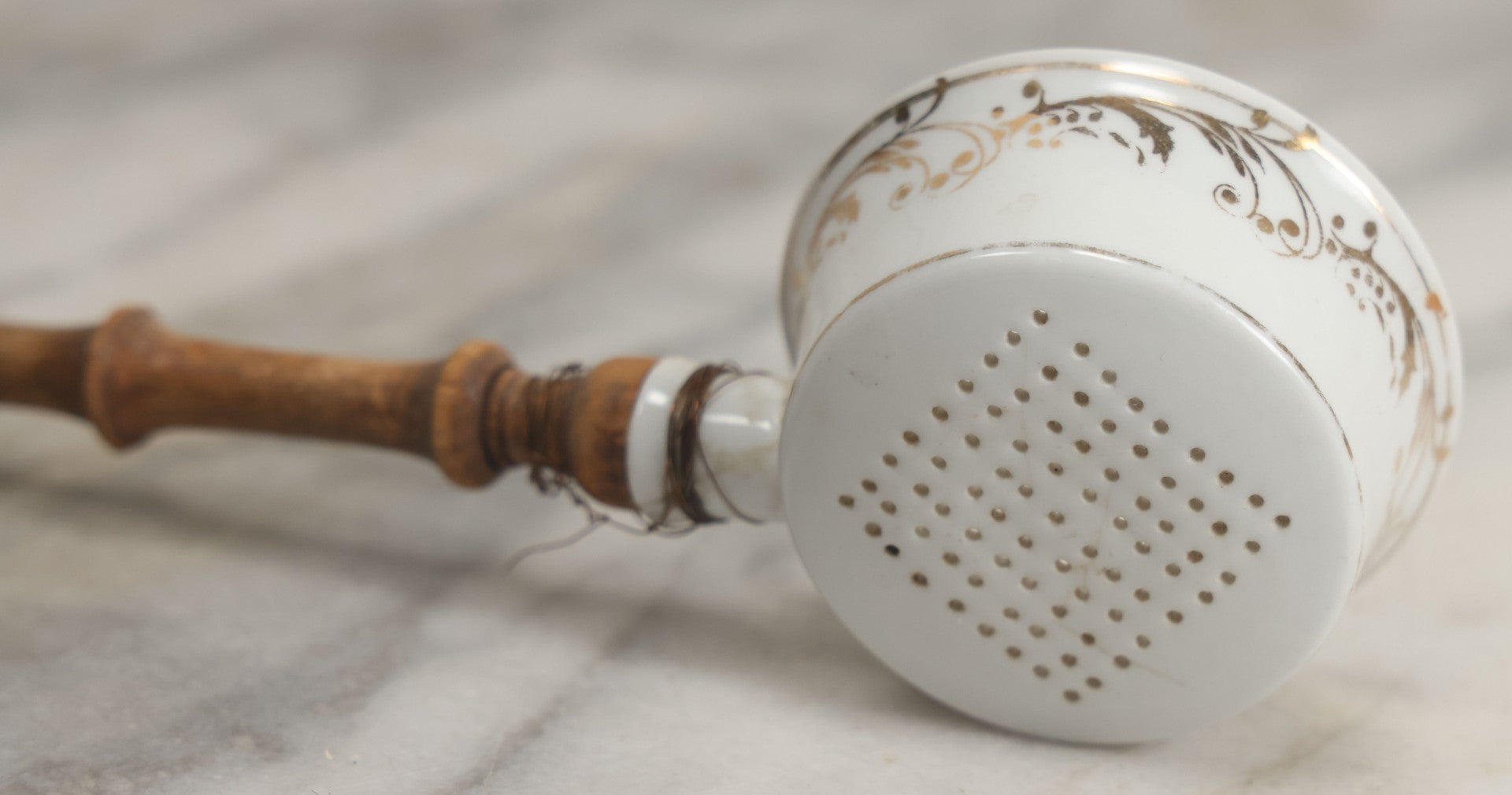 Lot 132 - Vintage Porcelain Tea Strainer With Gold Painted Details And Wire Attached Wooden Handle, Note Repairs