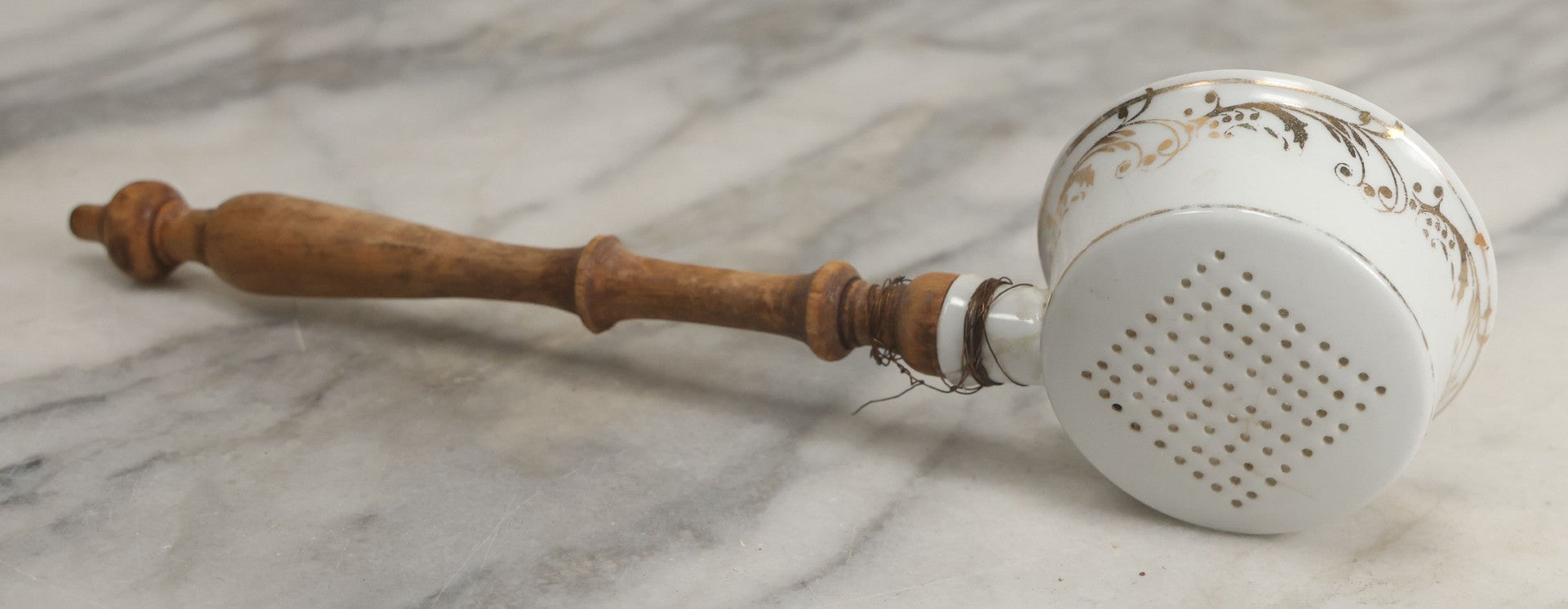 Lot 132 - Vintage Porcelain Tea Strainer With Gold Painted Details And Wire Attached Wooden Handle, Note Repairs