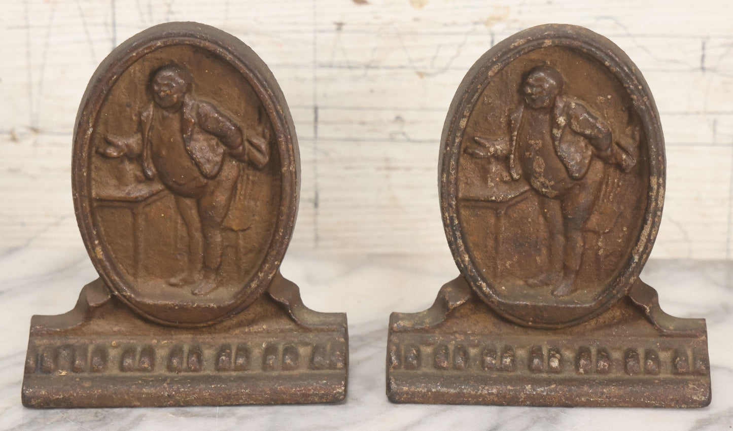 Lot 020 - Antique Cast Iron Bookends Featuring Portly Business Man In Suit With Handout