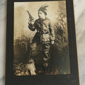 Lot 083 - Antique Boarded Photograph Of Young Boy Dressed As Native American Holding Revolver Pistol, Dated March 4, 1909