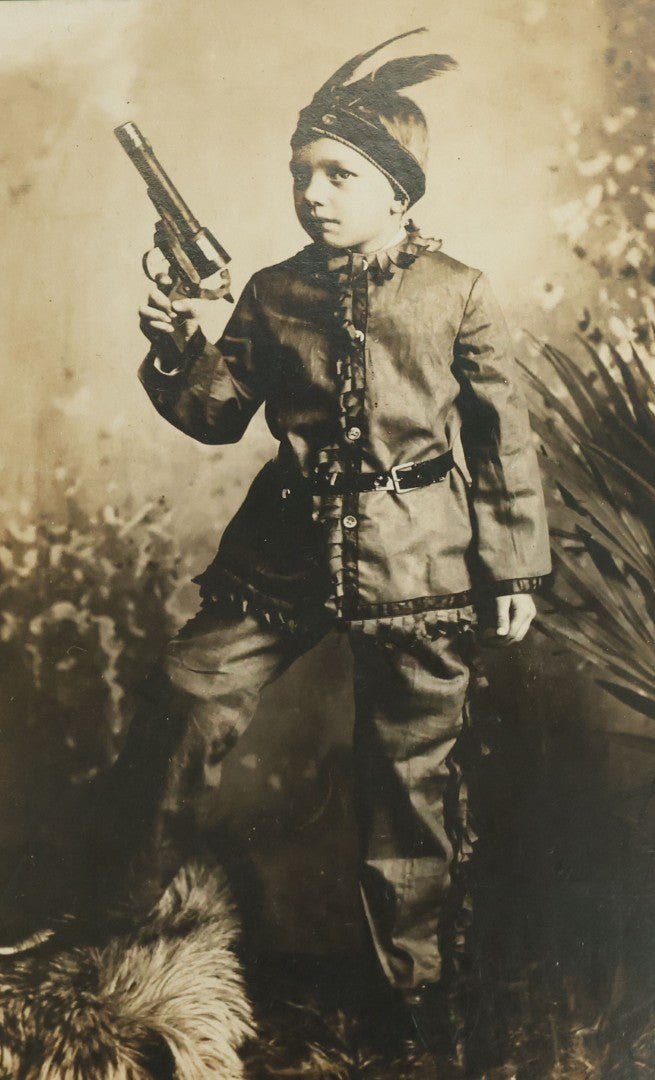 Lot 083 - Antique Boarded Photograph Of Young Boy Dressed As Native American Holding Revolver Pistol, Dated March 4, 1909