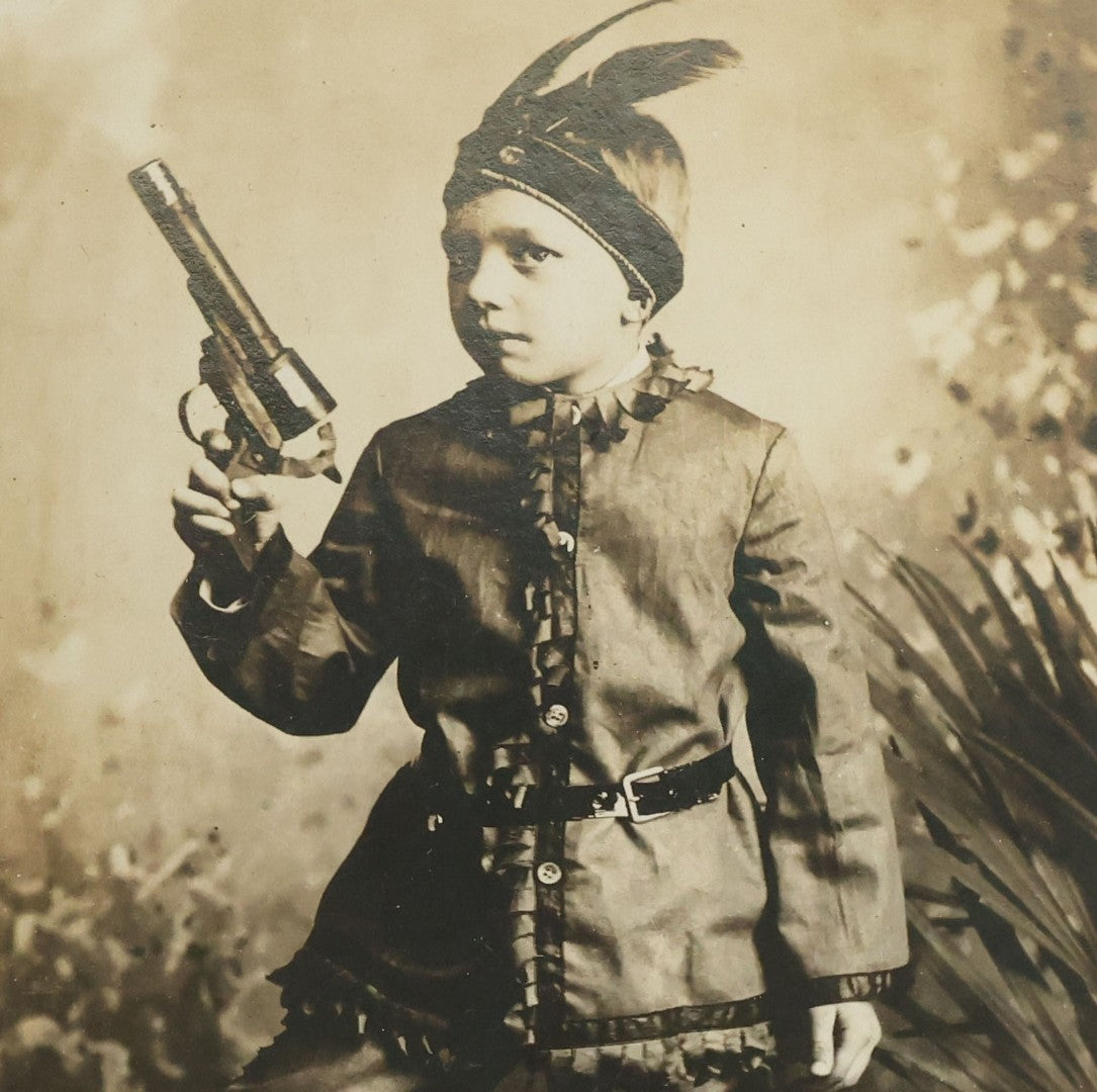 Lot 083 - Antique Boarded Photograph Of Young Boy Dressed As Native American Holding Revolver Pistol, Dated March 4, 1909