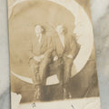 Lot 090 - Antique Real Photo Postcard R.P.P.C. Of Two Men Posing On Paper Moon Backdrop, One Man Identified As Art Anschutz