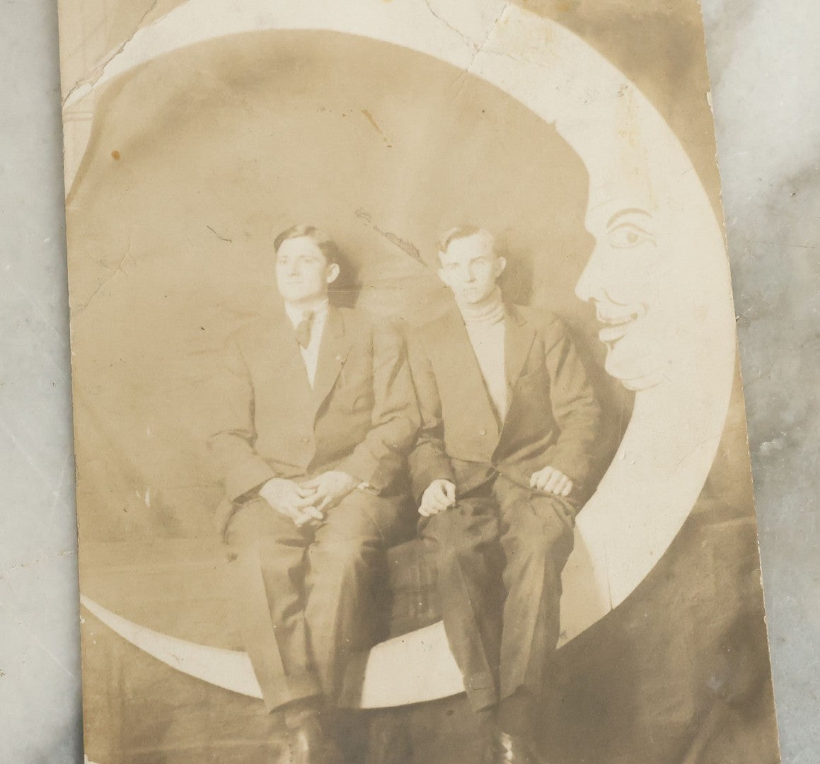 Lot 090 - Antique Real Photo Postcard R.P.P.C. Of Two Men Posing On Paper Moon Backdrop, One Man Identified As Art Anschutz