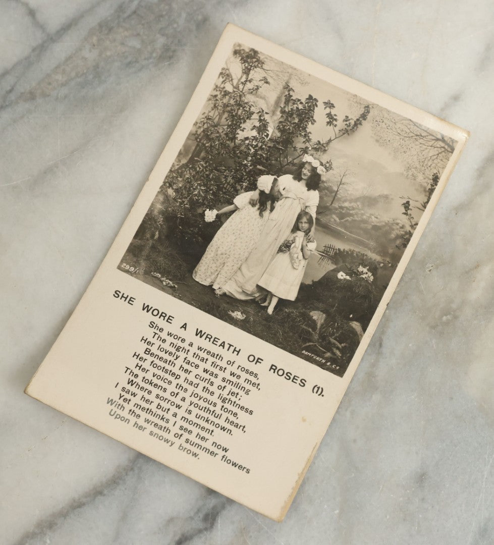 Lot 097 - Grouping Of 35 Antique Photographic Postcards From Bamforth's "Life Model Series," England And New York City, With Many Posed Studio Photographs And Series Including Rock Of Ages, The Little Hero, Excelsior, And Others