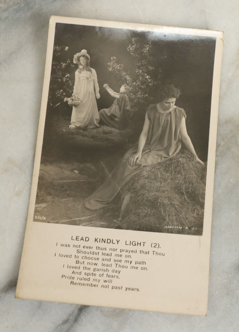 Lot 097 - Grouping Of 35 Antique Photographic Postcards From Bamforth's "Life Model Series," England And New York City, With Many Posed Studio Photographs And Series Including Rock Of Ages, The Little Hero, Excelsior, And Others