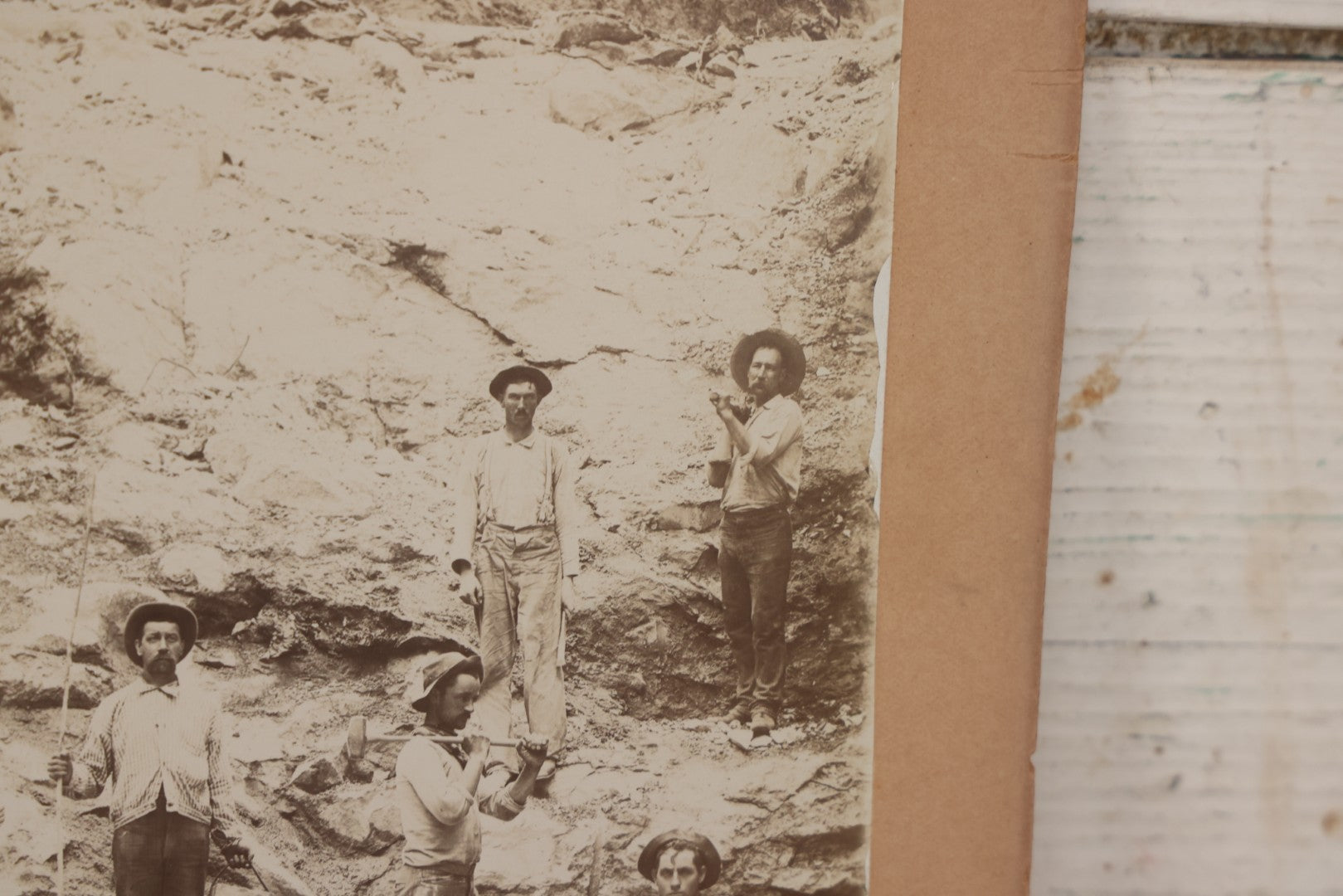 Lot 067 - Antique Boarded Occupational Photograph Of Group Of Seven Miners Posing In Quarry, Holding Sledgehammers And Other Tools