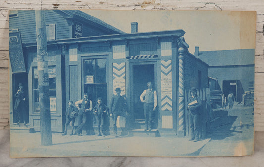 Lot 074 - Antique Unmounted Cyanotype Photograph Of The Workers And Proprietors Posing Outside Of The Storefronts Of L. DeLorme "Ladies And Gents Haircutting And Shampooing" And Dupont The Tailor, Harry Holland, Photographer, Worcester, Massachusetts