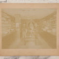 Lot 076 - Antique Boarded Photograph Of Three Men And Young Boy In Boot And Shoe Store, With Products And Advertising Visible In Photo