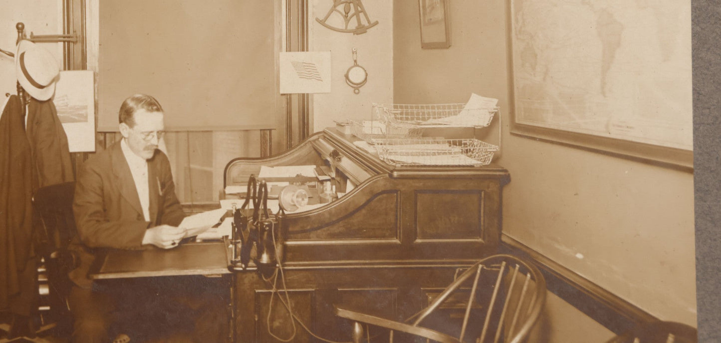 Lot 081 - Antique Boarded Occupational Photograph Of Man In His Office With Map, Sextant, And Telephone Visible In Photo