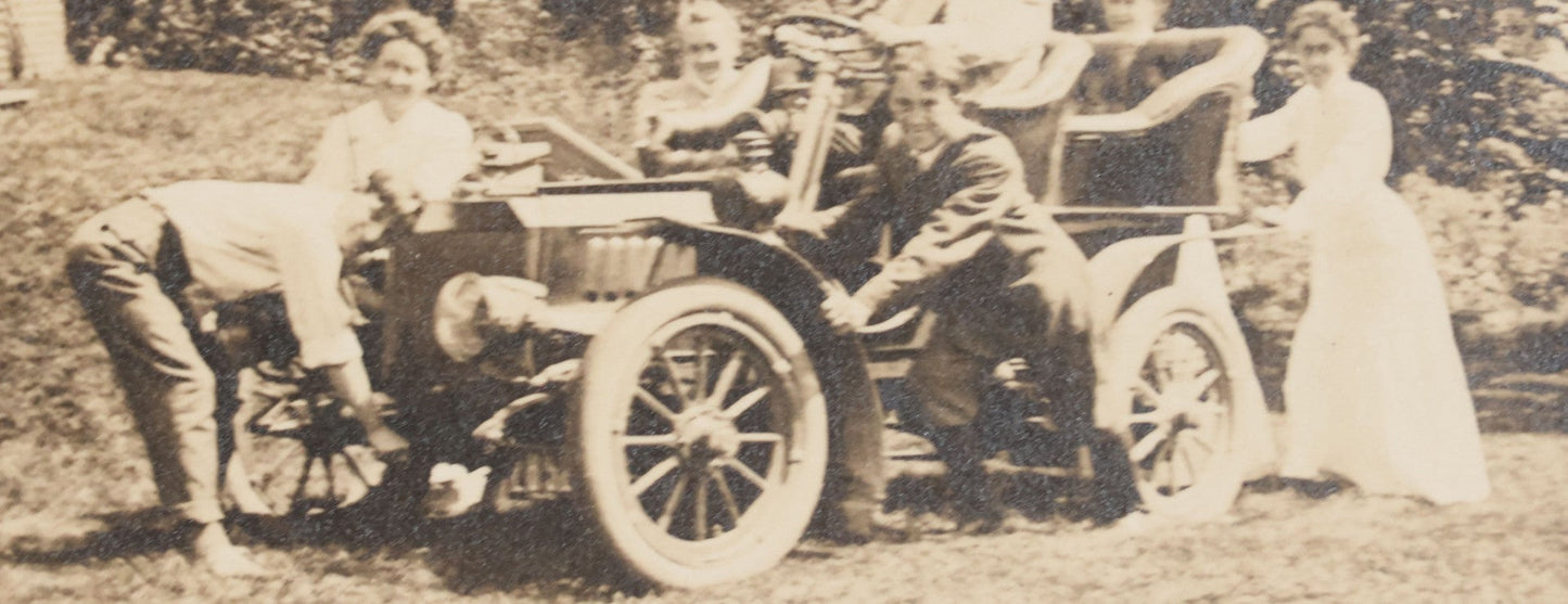 Lot 089 - Antique Boarded Photograph Of Group Of People Posing With And Starting An Early Automobile