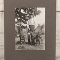 Lot 090 - Vintage Boarded Photograph Of Man In High Waisted Pants With Suspenders Holding Three Hounds On Leashes