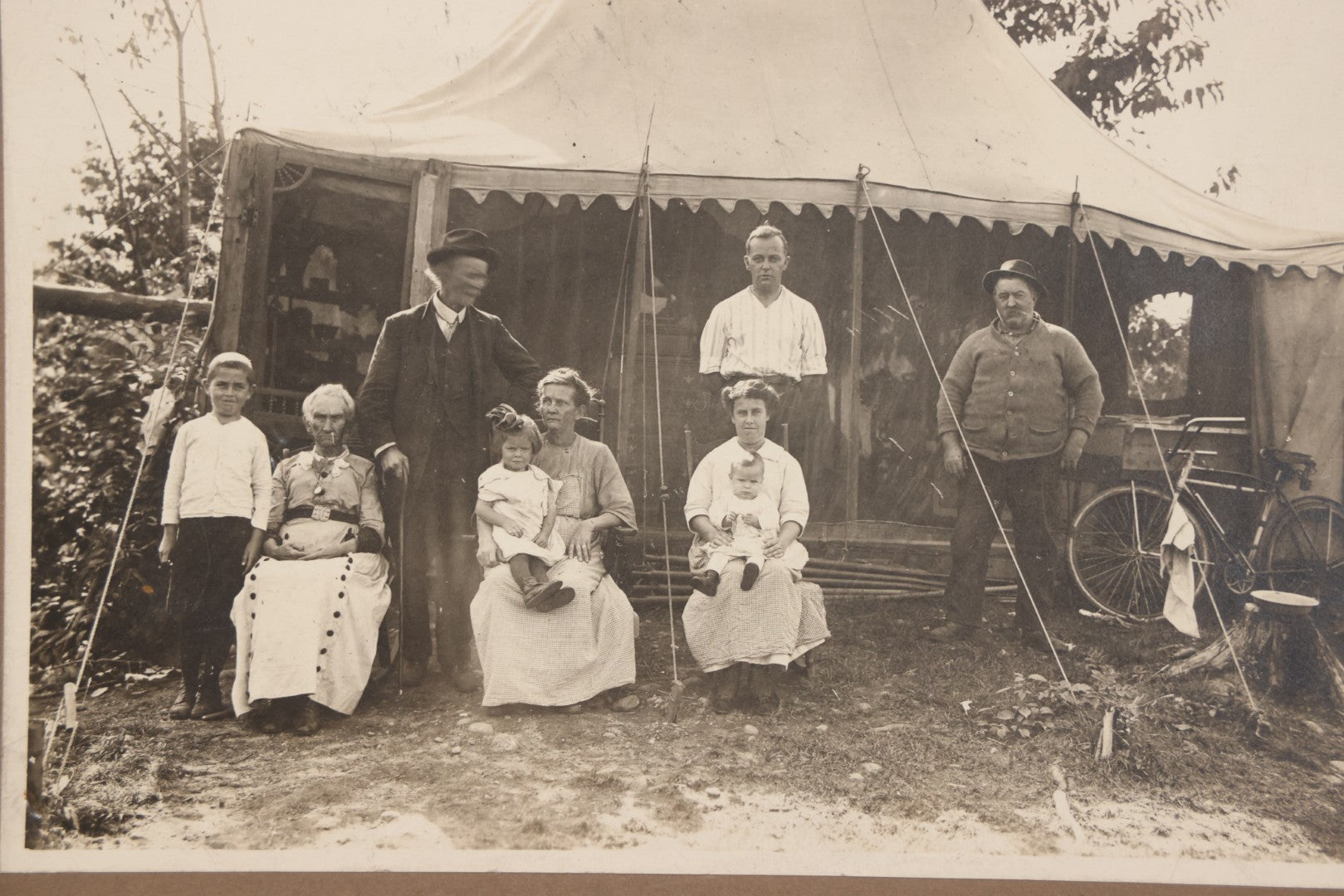 Lot 105 - Antique Boarded Photograph Of Three Generations Of Men Women And Children Posing Outside Of Tent, With Bicycle In Photo