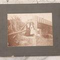 Lot 109 - Antique Boarded Photograph Of Two Women And Man Posing Beside Partially Collapsed Railroad Bridge