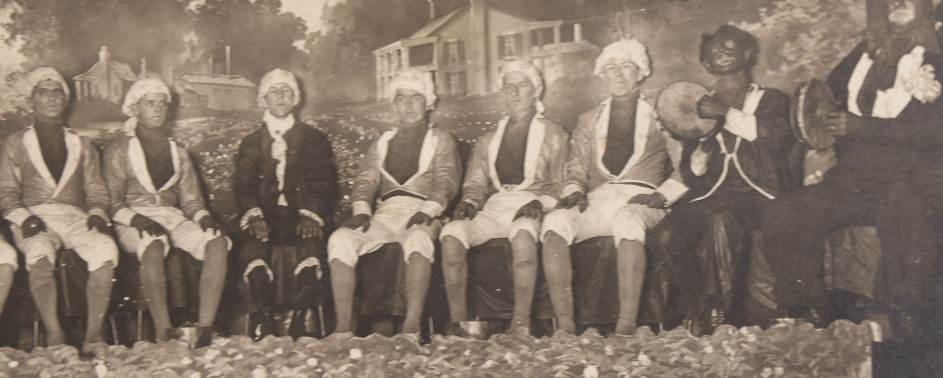 Lot 110 - Antique Boarded Photograph Of Stage Performers In Costume With Painted Backdrop And Drum Set, Music Stands In Foreground
