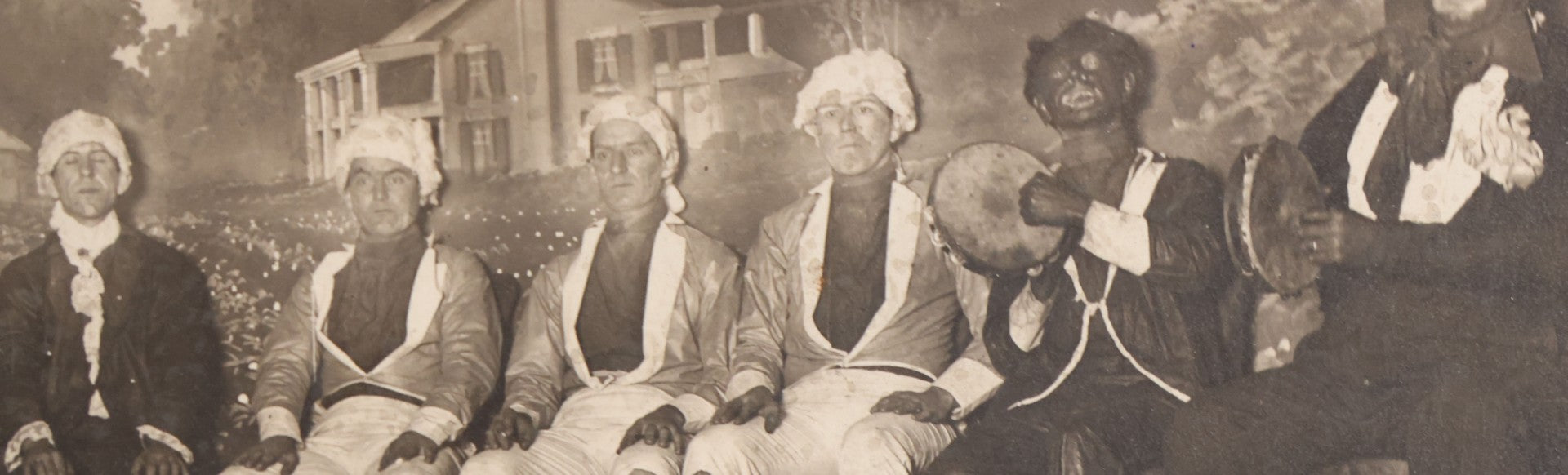 Lot 110 - Antique Boarded Photograph Of Stage Performers In Costume With Painted Backdrop And Drum Set, Music Stands In Foreground