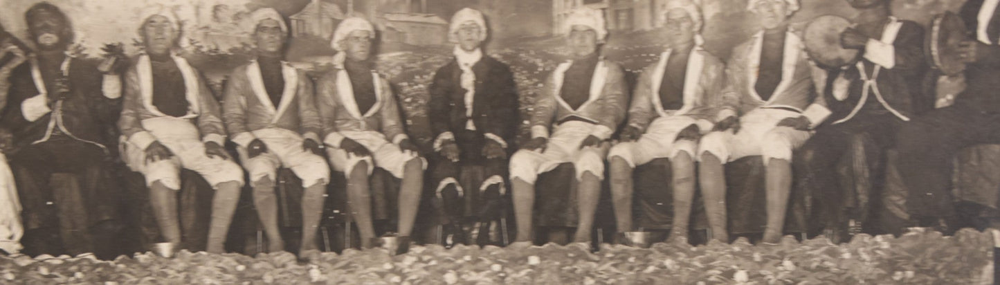 Lot 110 - Antique Boarded Photograph Of Stage Performers In Costume With Painted Backdrop And Drum Set, Music Stands In Foreground