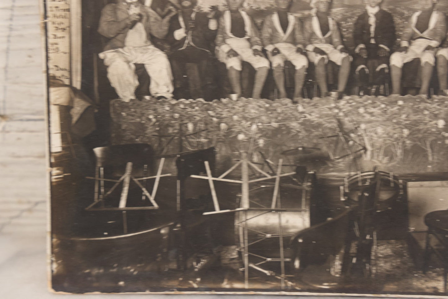 Lot 110 - Antique Boarded Photograph Of Stage Performers In Costume With Painted Backdrop And Drum Set, Music Stands In Foreground