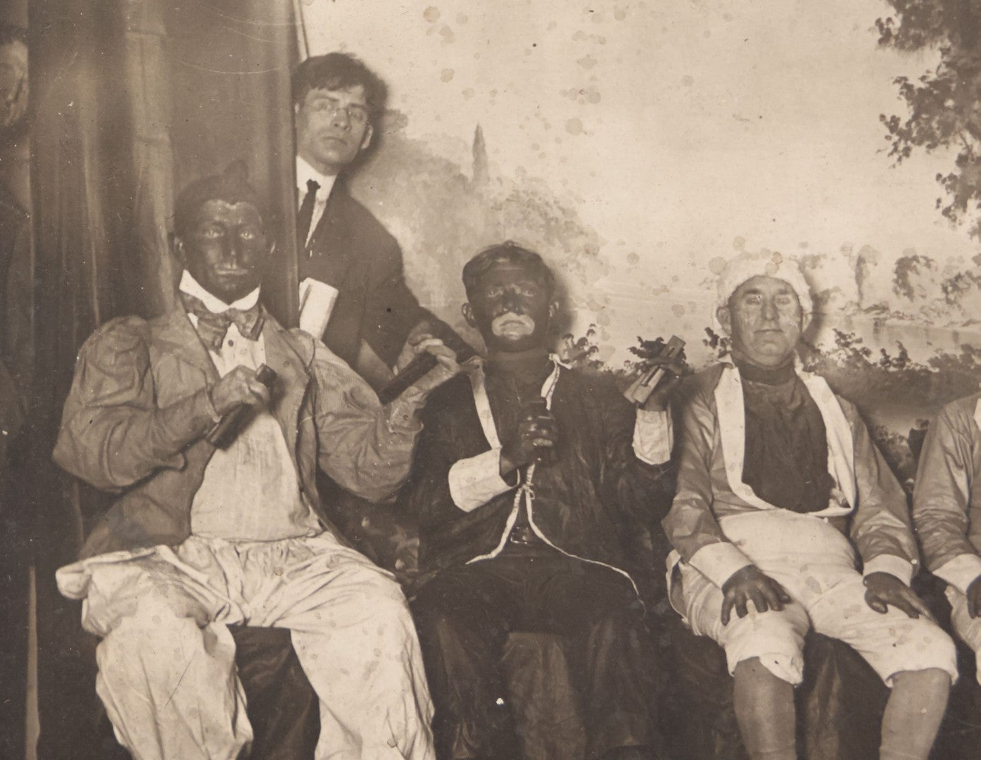 Lot 110 - Antique Boarded Photograph Of Stage Performers In Costume With Painted Backdrop And Drum Set, Music Stands In Foreground