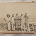 Lot 113 - Small Antique Boarded Photograph Of Five Men Goofing Off In Silly Costumes, Wearing Kitchen Pots And Pans As Hats, Pan Lids As Symbols, Standing In Front Of Rock Wall On Shore, Note Board Is Trimmed