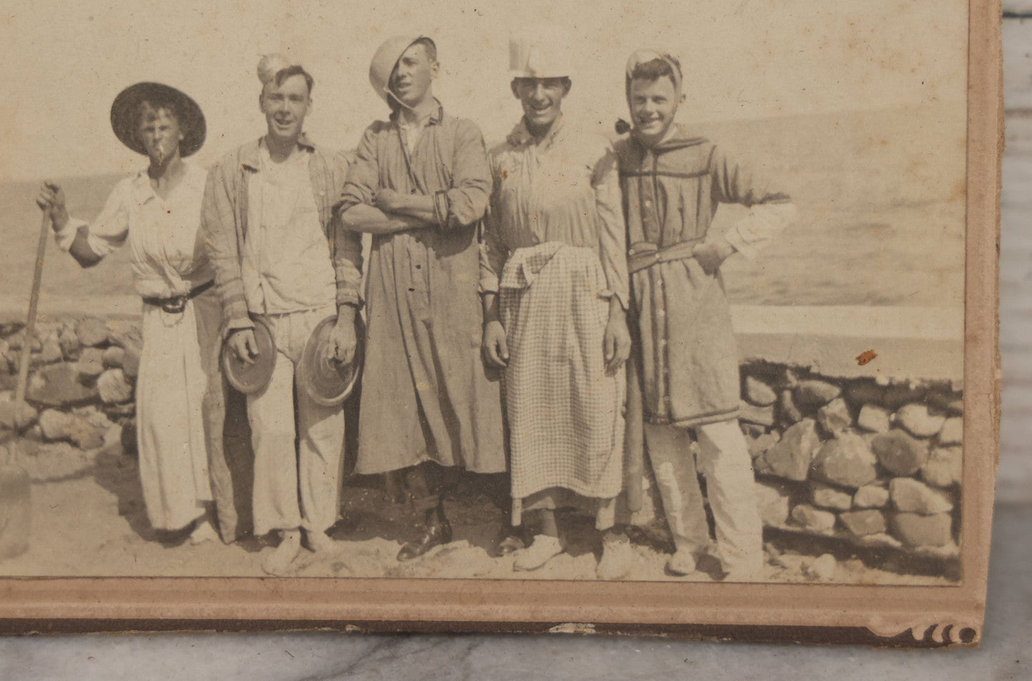 Lot 113 - Small Antique Boarded Photograph Of Five Men Goofing Off In Silly Costumes, Wearing Kitchen Pots And Pans As Hats, Pan Lids As Symbols, Standing In Front Of Rock Wall On Shore, Note Board Is Trimmed