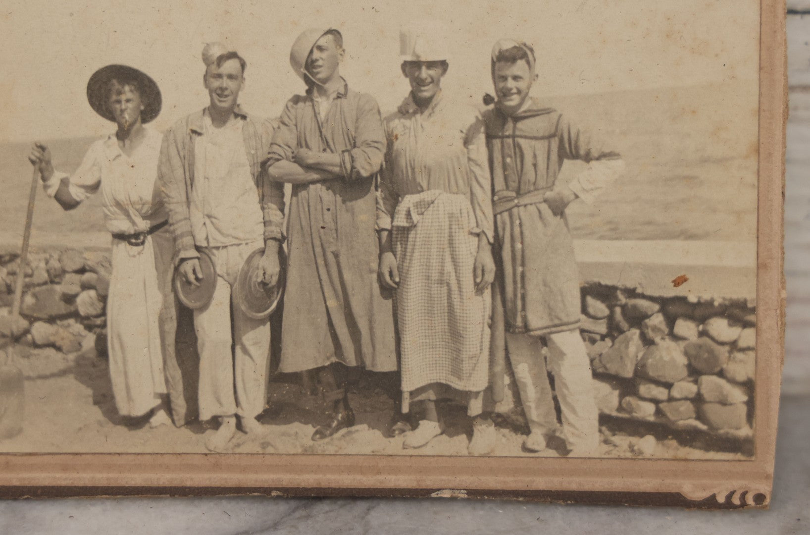 Lot 113 - Small Antique Boarded Photograph Of Five Men Goofing Off In Silly Costumes, Wearing Kitchen Pots And Pans As Hats, Pan Lids As Symbols, Standing In Front Of Rock Wall On Shore, Note Board Is Trimmed