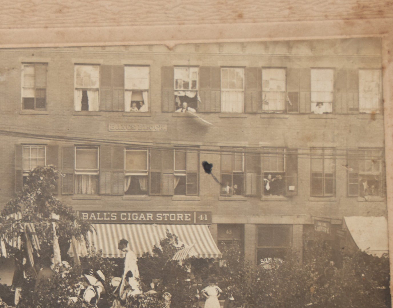 Lot 114 - Antique Boarded Photograph Of Patriotic Parade With Swedish Float With "Hoganas" Banner, Sign On Building "Bangs Block" (Likely Springfield, Mass.), Other Signs "Ball's Cigar Store", "Ladies & Gents Lounge", Barber Shop And "Sam Sing Laundry"