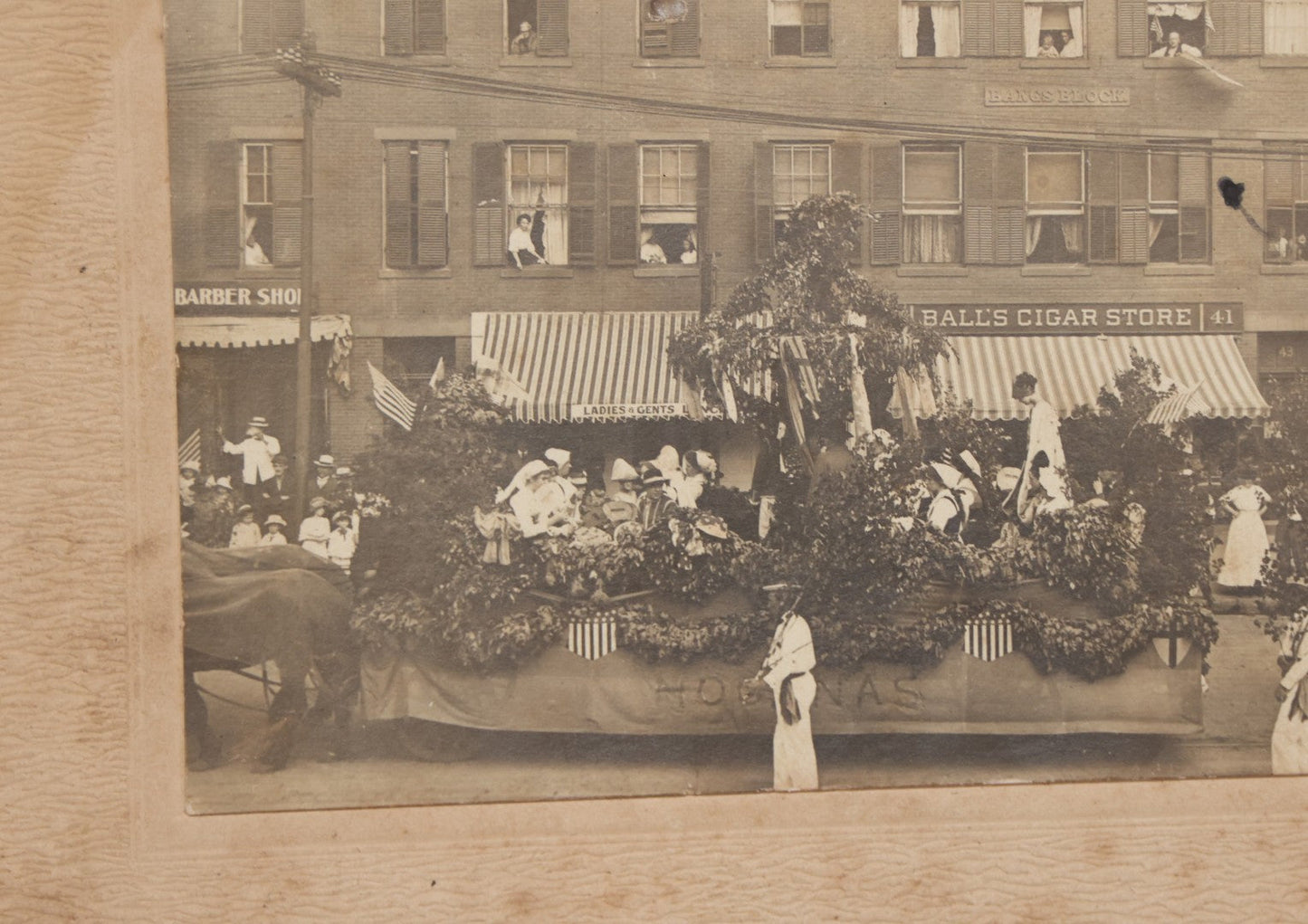 Lot 114 - Antique Boarded Photograph Of Patriotic Parade With Swedish Float With "Hoganas" Banner, Sign On Building "Bangs Block" (Likely Springfield, Mass.), Other Signs "Ball's Cigar Store", "Ladies & Gents Lounge", Barber Shop And "Sam Sing Laundry"