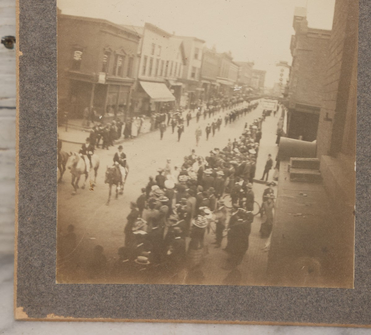 Lot 115 - Pair Of Antique Boarded Photographs Of Parade And Onlookers With Early Automobiles And People On Horseback Signs For "Red Front Store" And "National Bank"