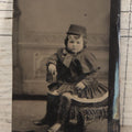 Lot 130 - Single Antique Tintype Photograph Of Young Boy In Dress With Cap And Chubby Face