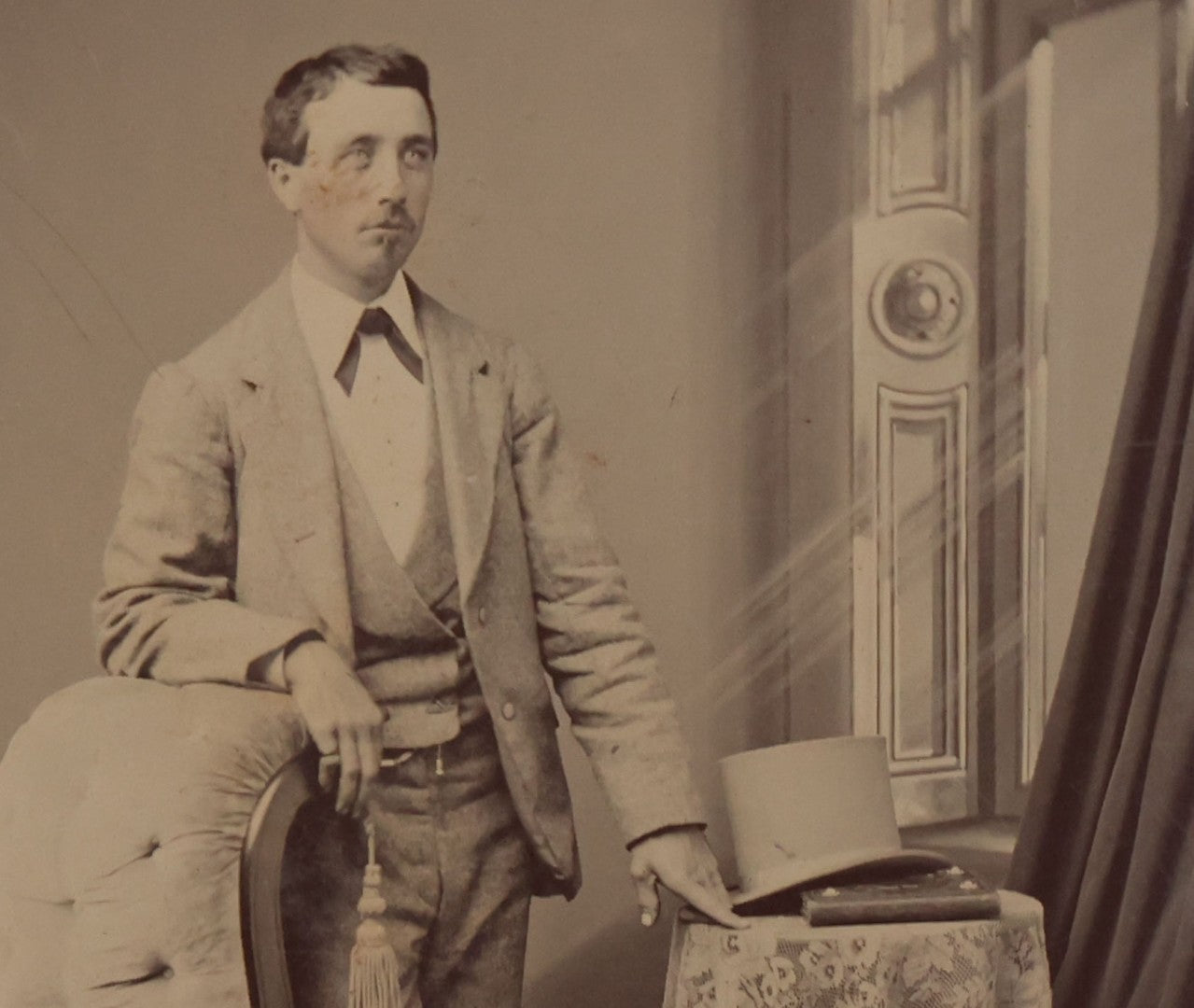 Lot 131 - Single Antique Tintype Photograph Of Confident Man Leaning On Chair Beside Table With Tophat And Book