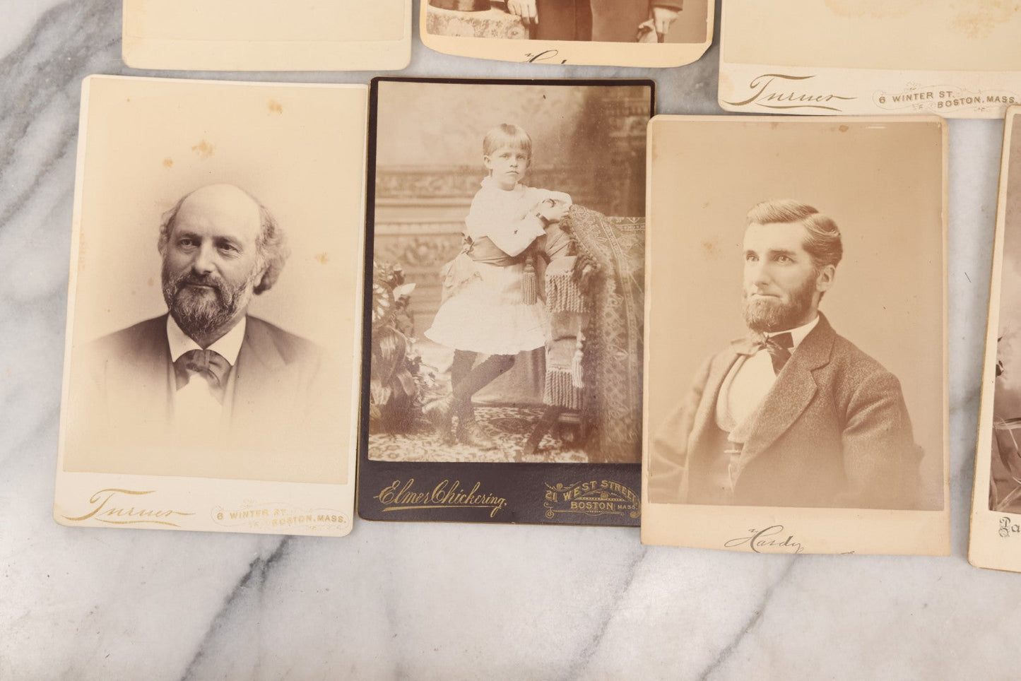Lot 133 - Grouping Of 18 Antique Cabinet Card Photographs Including Pale Woman With Hand Muff, Friendly Man With Beard, Young Man With Bowler Cap And Swagger Stick, Boy Posing With Crane Table, And More