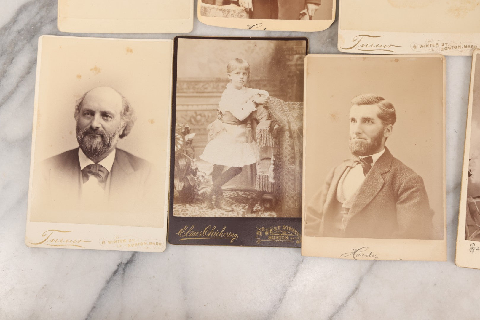 Lot 133 - Grouping Of 18 Antique Cabinet Card Photographs Including Pale Woman With Hand Muff, Friendly Man With Beard, Young Man With Bowler Cap And Swagger Stick, Boy Posing With Crane Table, And More