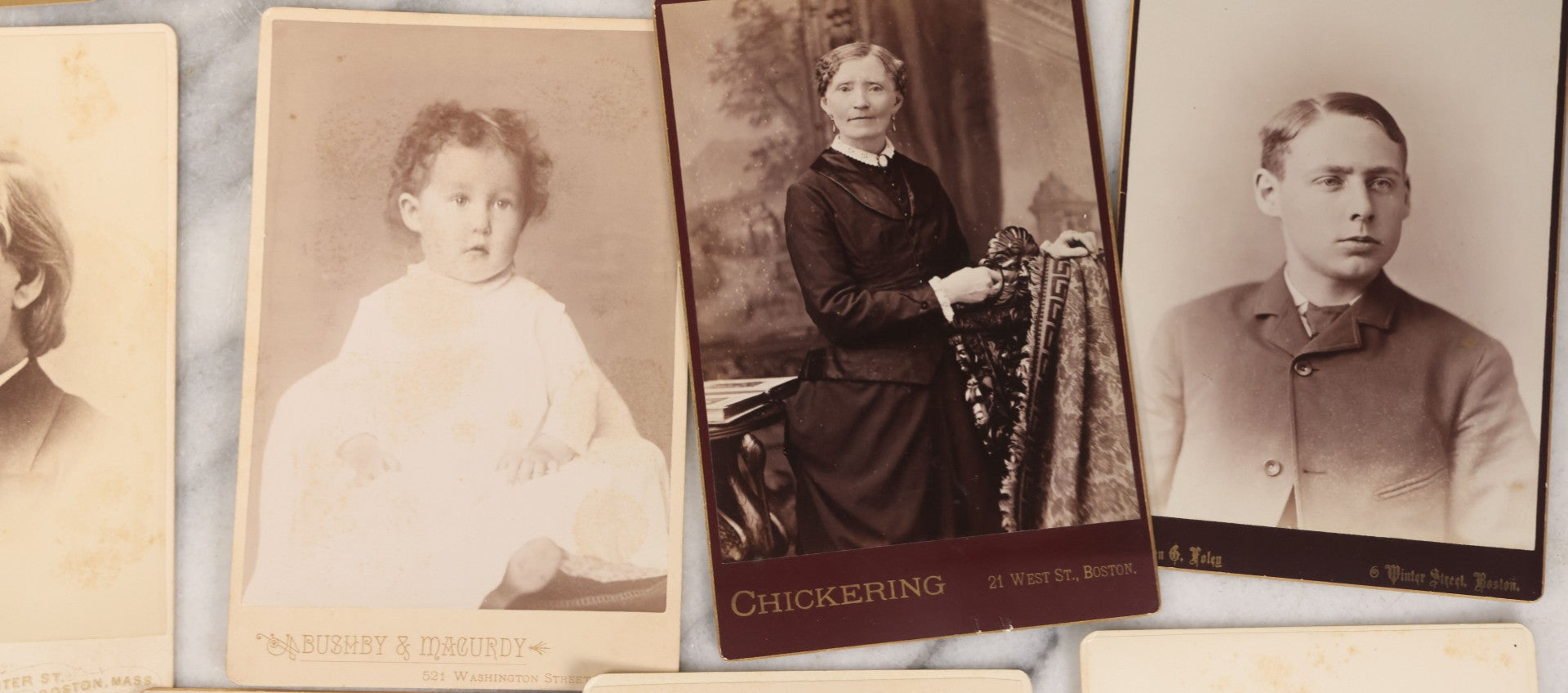 Lot 133 - Grouping Of 18 Antique Cabinet Card Photographs Including Pale Woman With Hand Muff, Friendly Man With Beard, Young Man With Bowler Cap And Swagger Stick, Boy Posing With Crane Table, And More