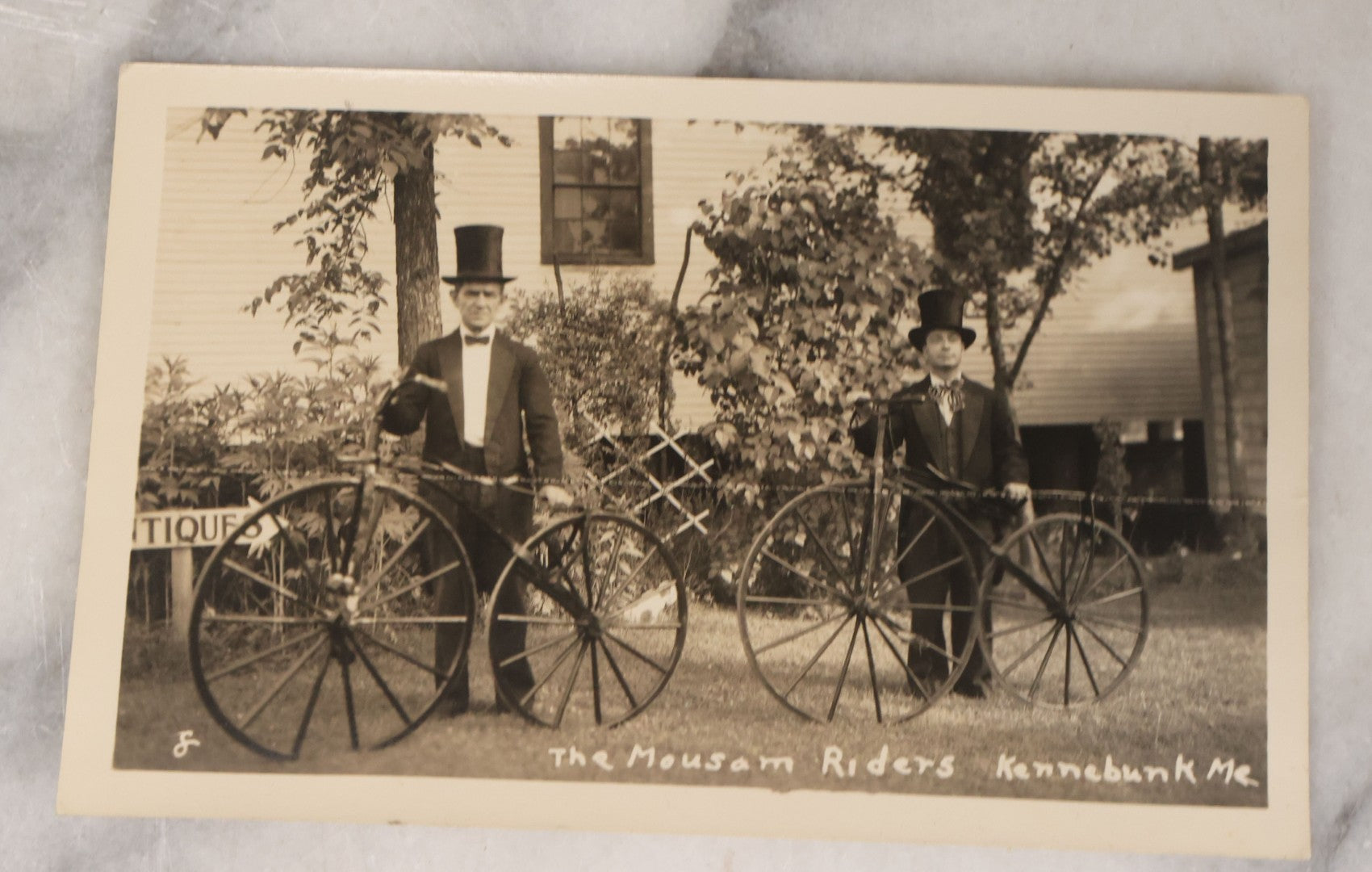 Lot 139 - Grouping Of 25 Vintage Snapshot Vernacular Photographs Including Girls On Motorcycle With Sidecar, Men In Tophats Posing With Bicycles, Man Flipping Off Camera, And More