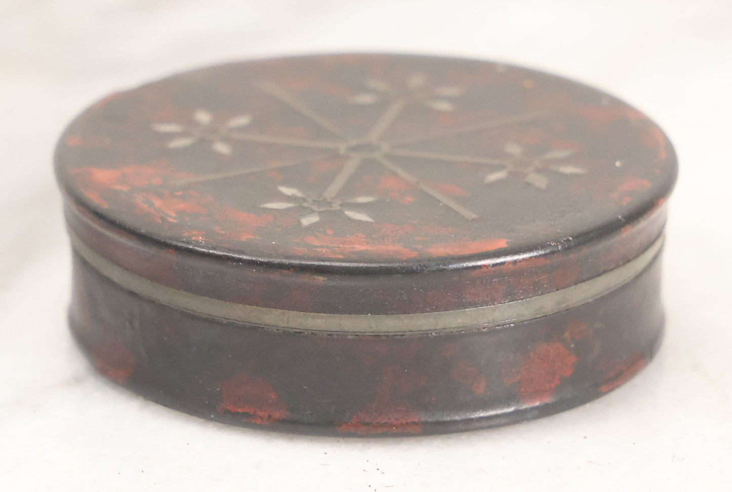 Lot 012 - Antique Laquered Papier Mache Dresser Box With Inlaid Geometric Cover And Red Paint Marbling, Note Loss To Edge Of Lid