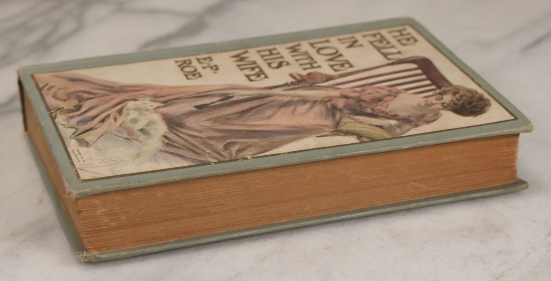 Lot 110 - "He Fell In Love With His Wife" Antique Romance Novel By Edward P. Roe, With Cover Art Of Woman Playing With Fluffy White Cat, Illustrated By Z.P. Nikolaki, Grosset & Dunlap, Publishers, New York, Copyright 1911, By Dodd, Mead & Co.