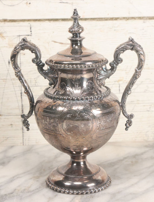 Lot 014 - Vintage Ornate Silverplate Urn With Decorative Handles, Floral Design, Lid, Manufactured By Meriden Britannia Company, No. 1835, 10" Height
