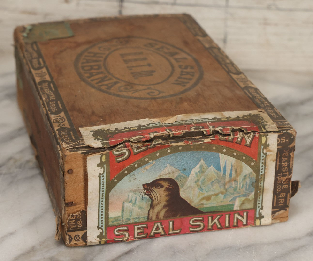Lot 115 - Antique Wooden Cigar Box For "Seal Skin" Cigars, Manufactured By Dearstyne Bros. Tobacco Co., Albany, New York, With Lithographed Interior And Exterior Labels With Arctic Seal Graphics
